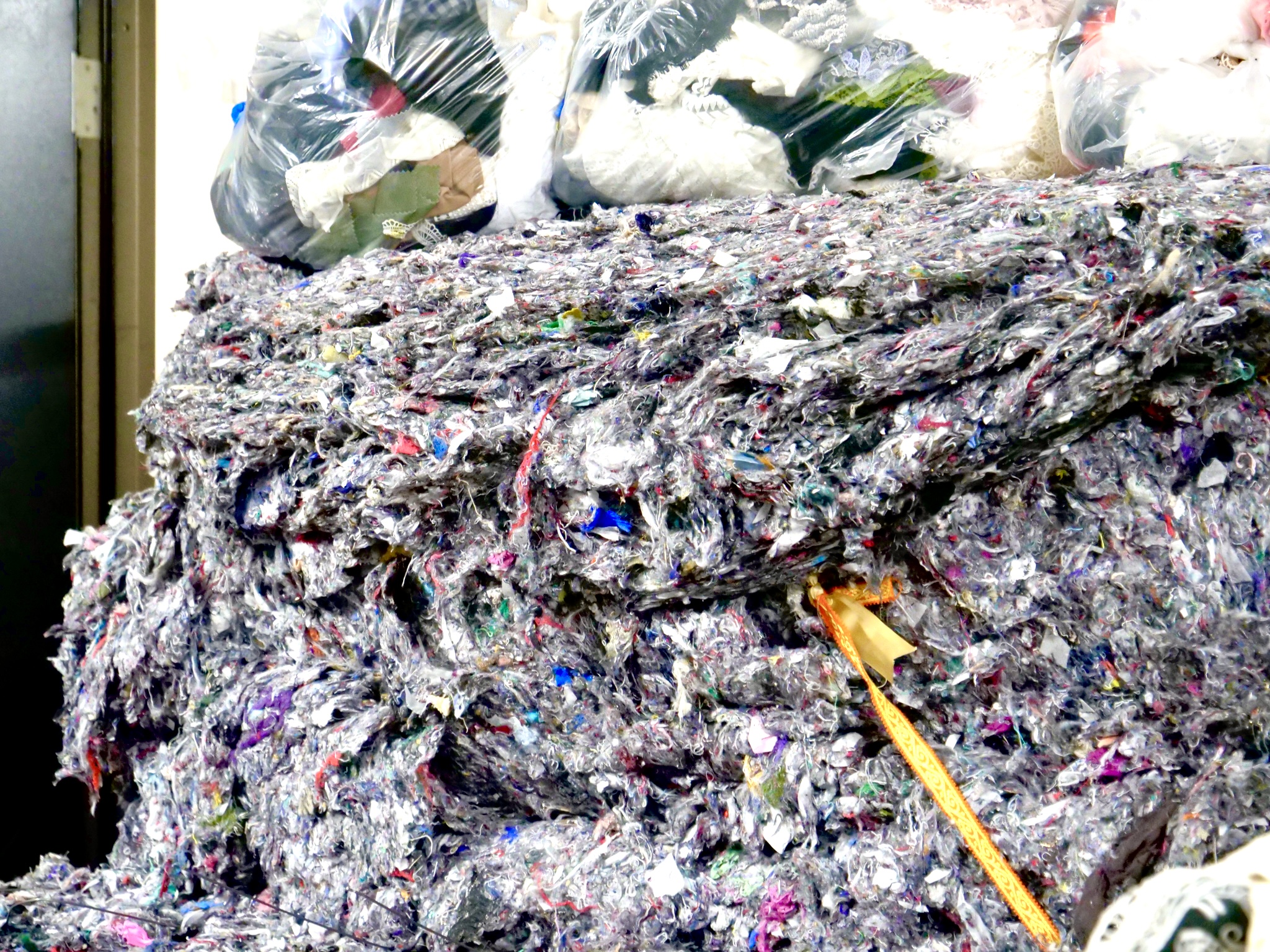 Excess fabric material and scraps can be recycled when it is shredded, also known as shoddy.
