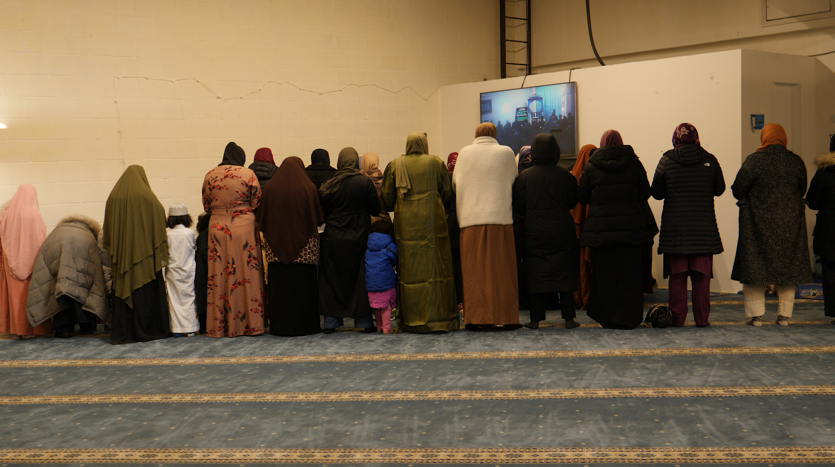 Women grouping together for Jummah prayer in the Muslim Community Center.
